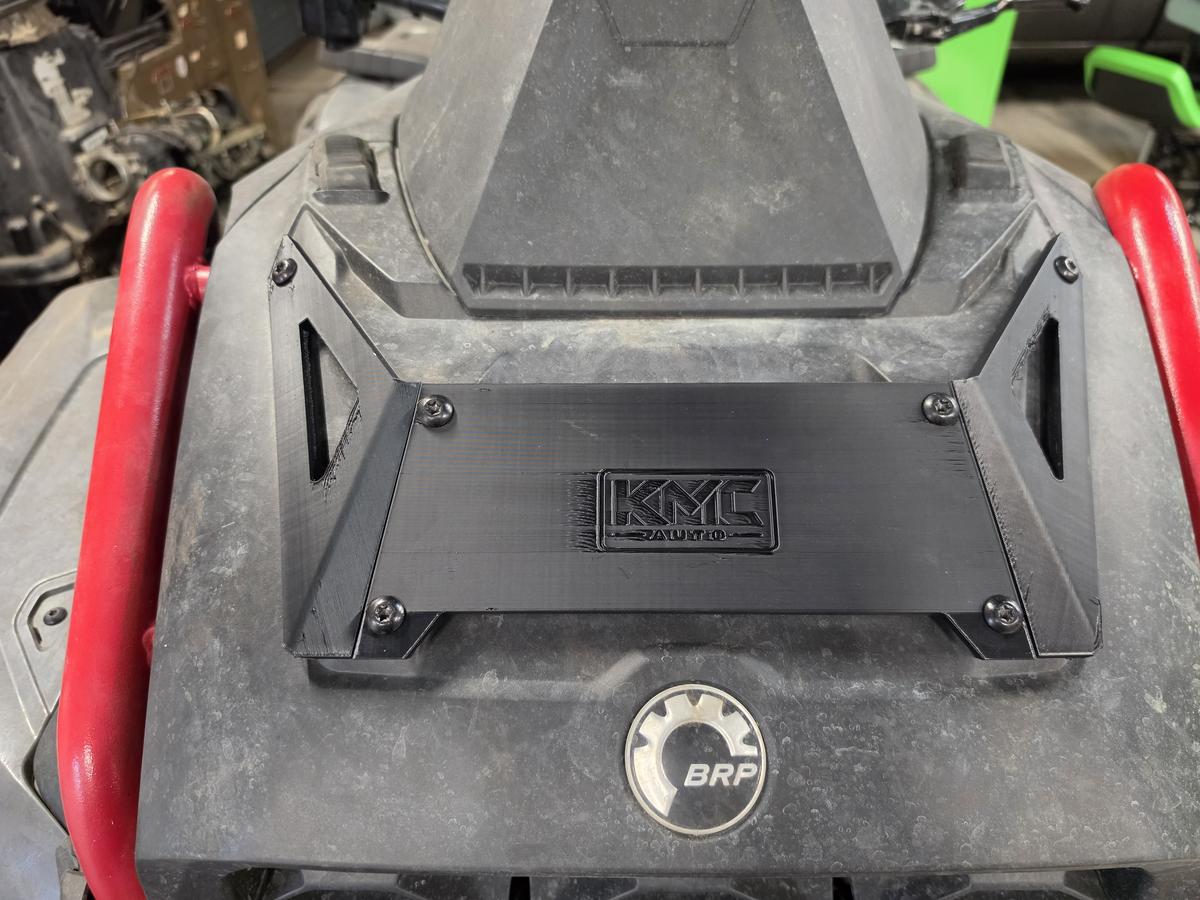 Black KMC Auto front plate on a Gen 3 Can-Am Outlander XMR, close-up