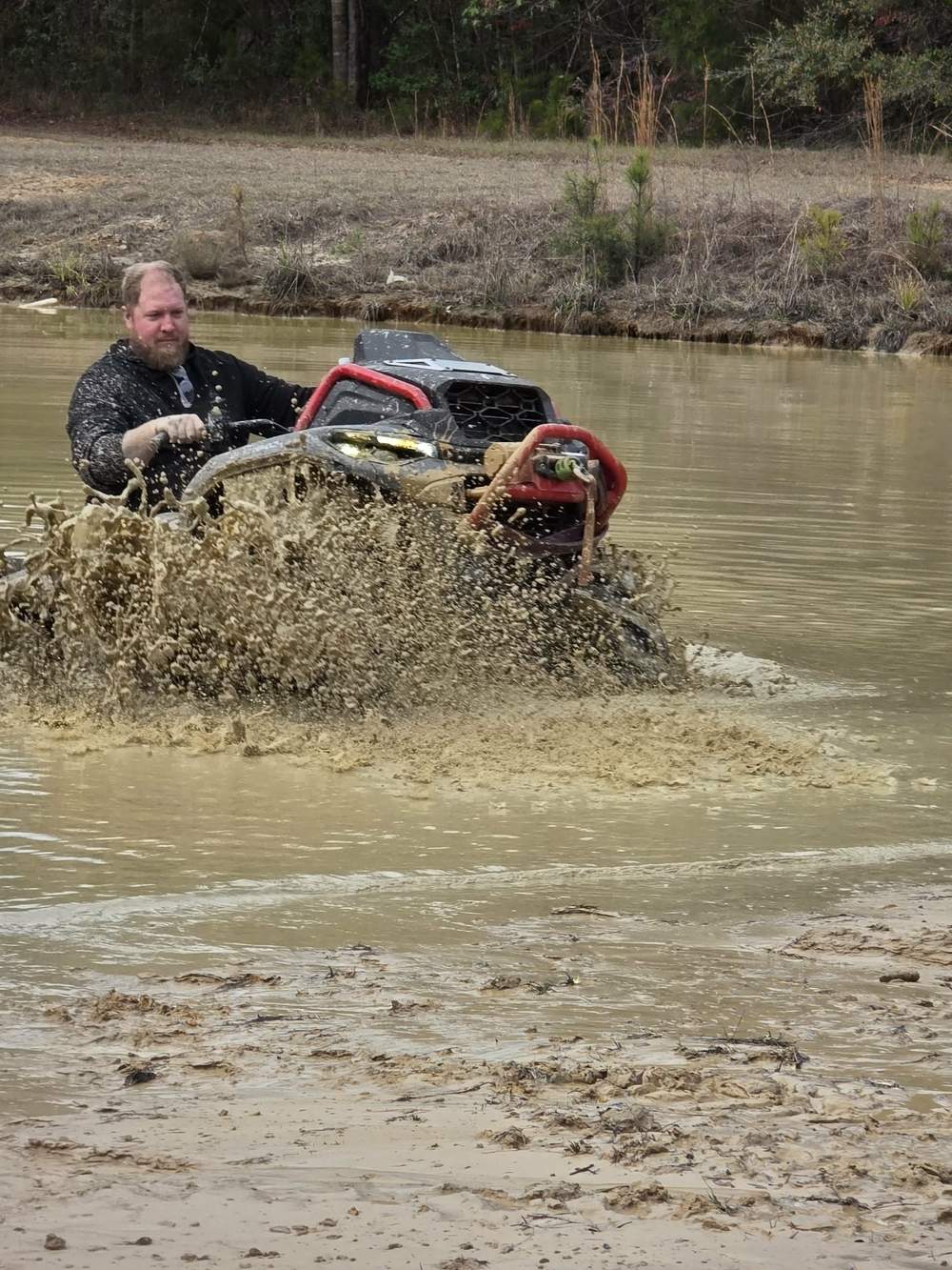Kolby riding his Can-Am through mud